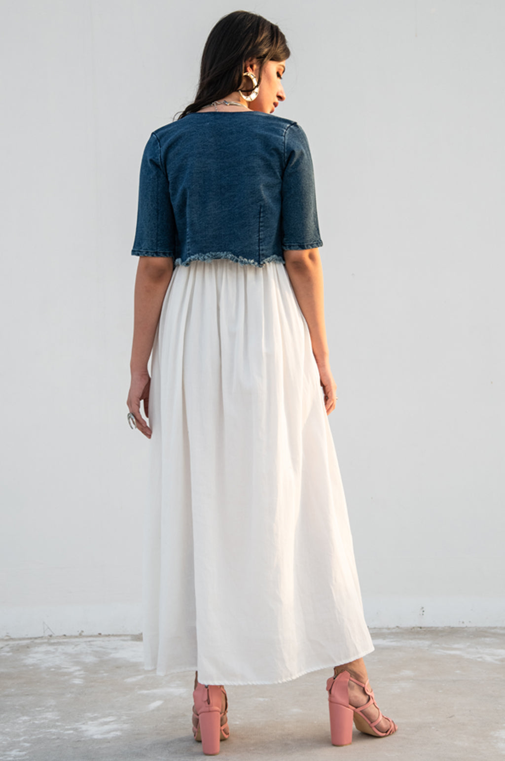 Model posing and looking into the camera, dressed in our white ‘Tannon Long Dress’.