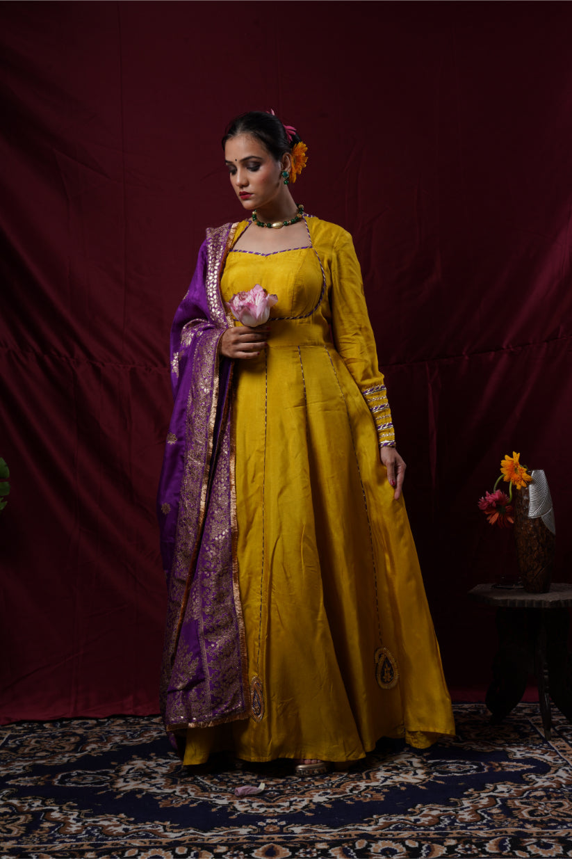 A mustard yellow anarkali gown