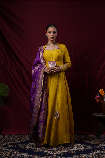 A mustard yellow anarkali gown