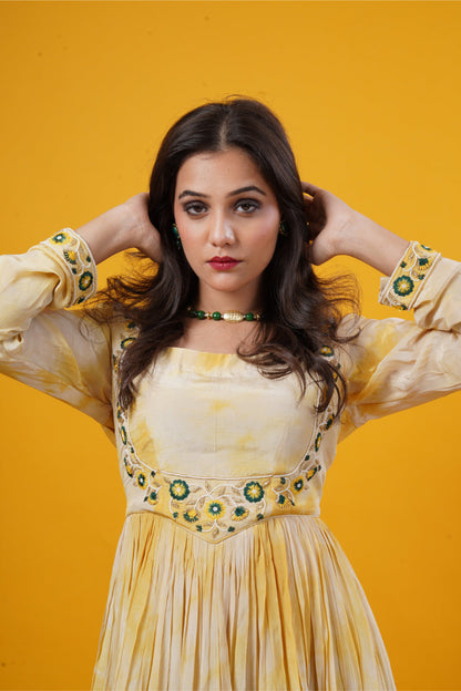 A mustard yellow tie-dye gown with a double yoke